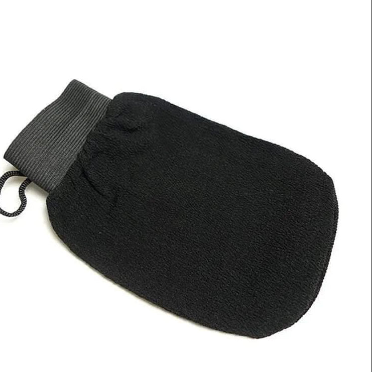 Black exfoliating mitt kessa scrub glove on white background for self-tanning and body exfoliation
