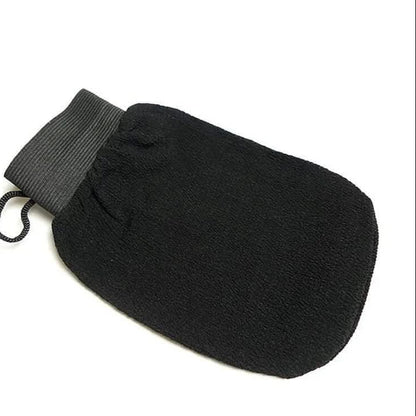 Black exfoliating mitt kessa scrub glove on white background for self-tanning and body exfoliation